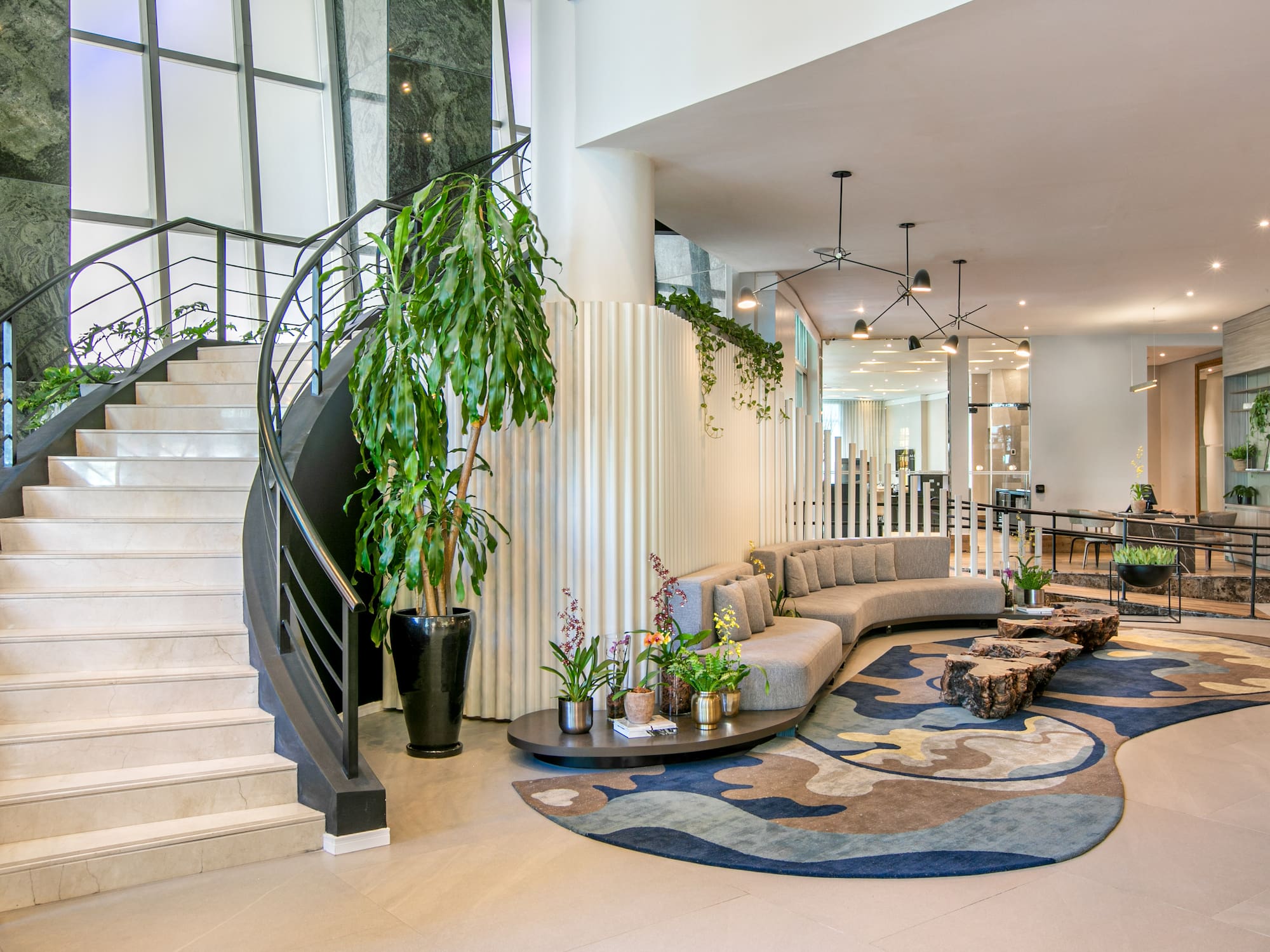 a lobby with a spiral staircase and a couch