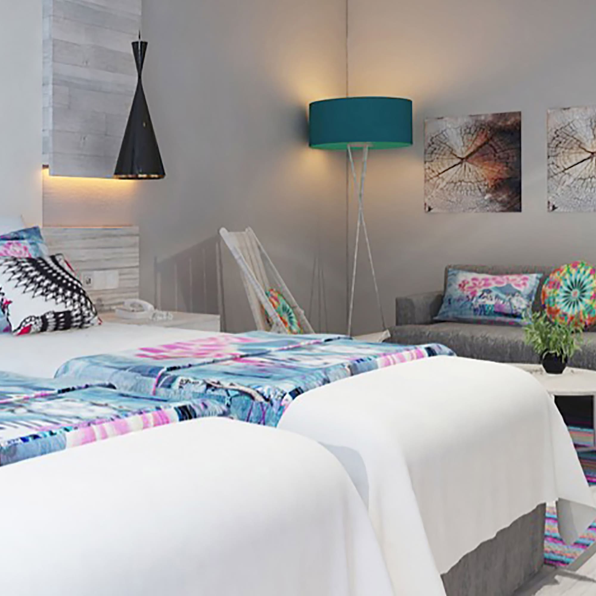 a room with two beds and a couch