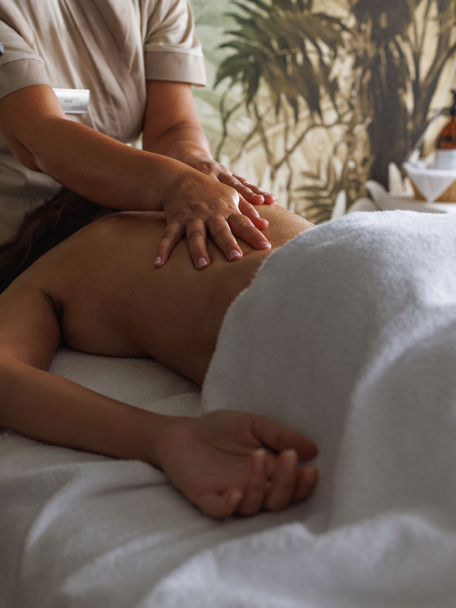Relaxing back massage by a therapist's hands at a wellness spa.