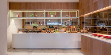 a kitchen with a counter and shelves
