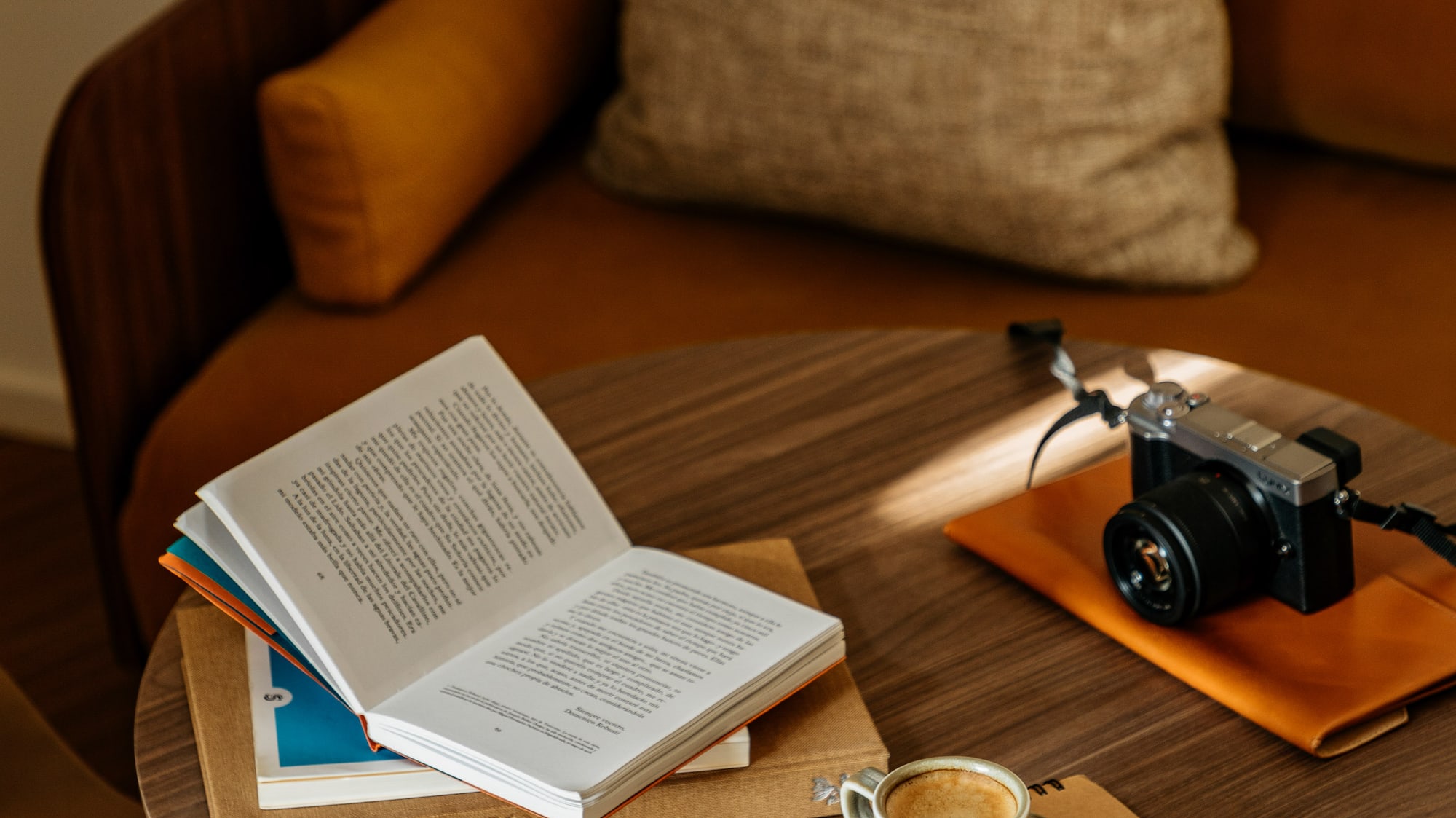 a coffee cup and a book on a round table