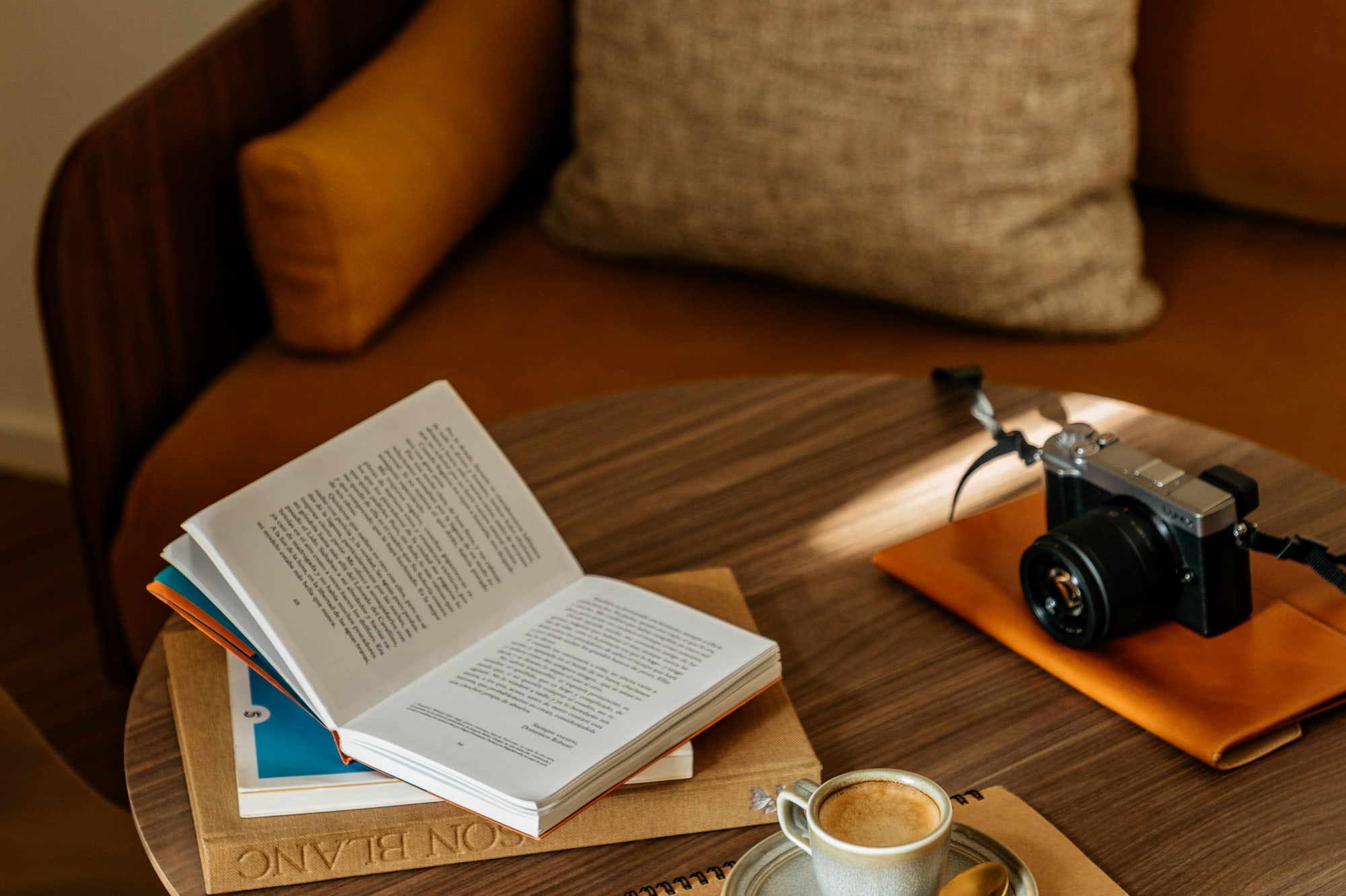 a coffee cup and a book on a round table