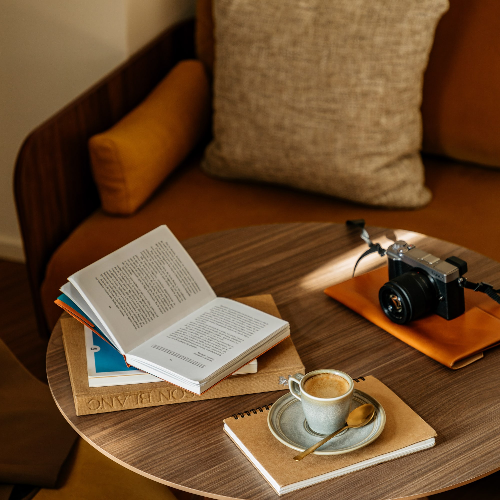 a coffee cup and a book on a round table