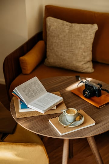 a coffee cup and a book on a round table