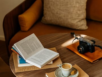 a coffee cup and a book on a round table
