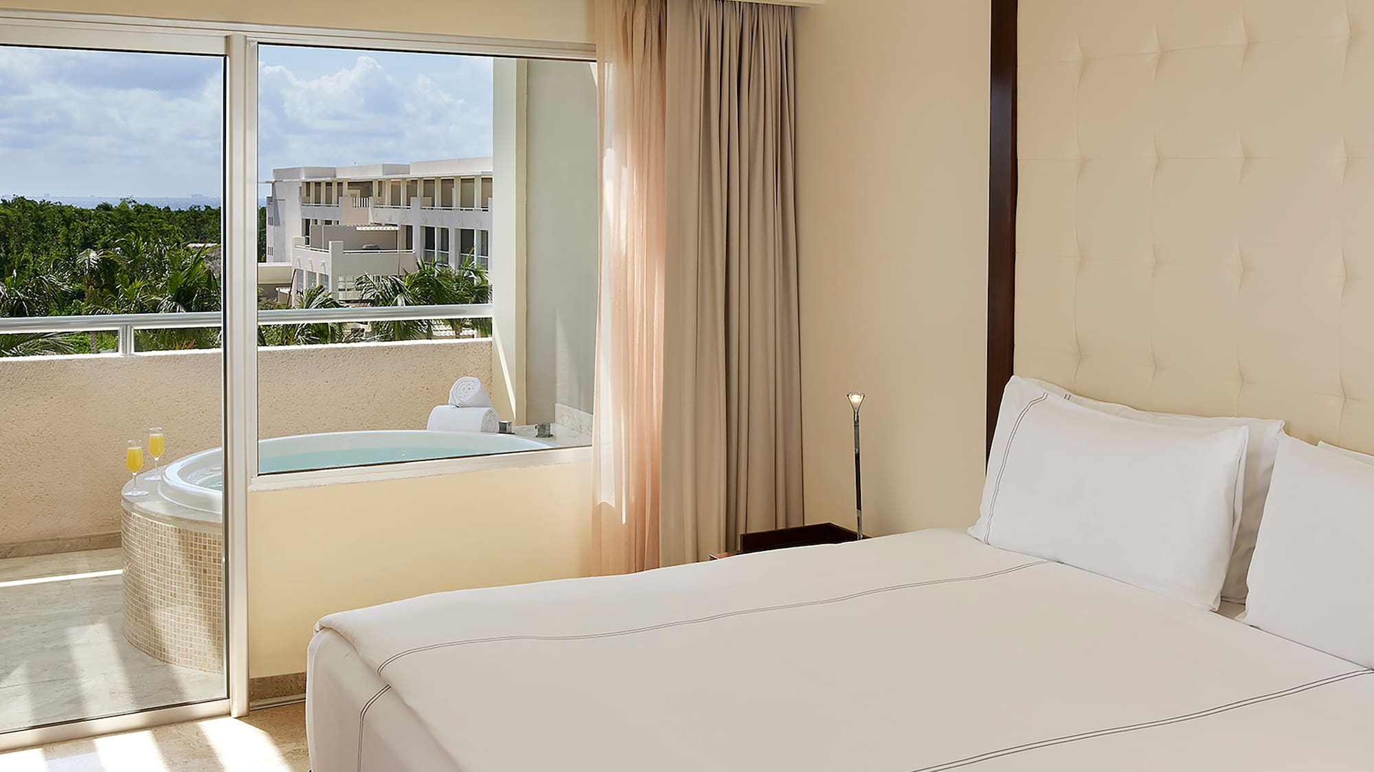 a bed with a glass door and a jacuzzi