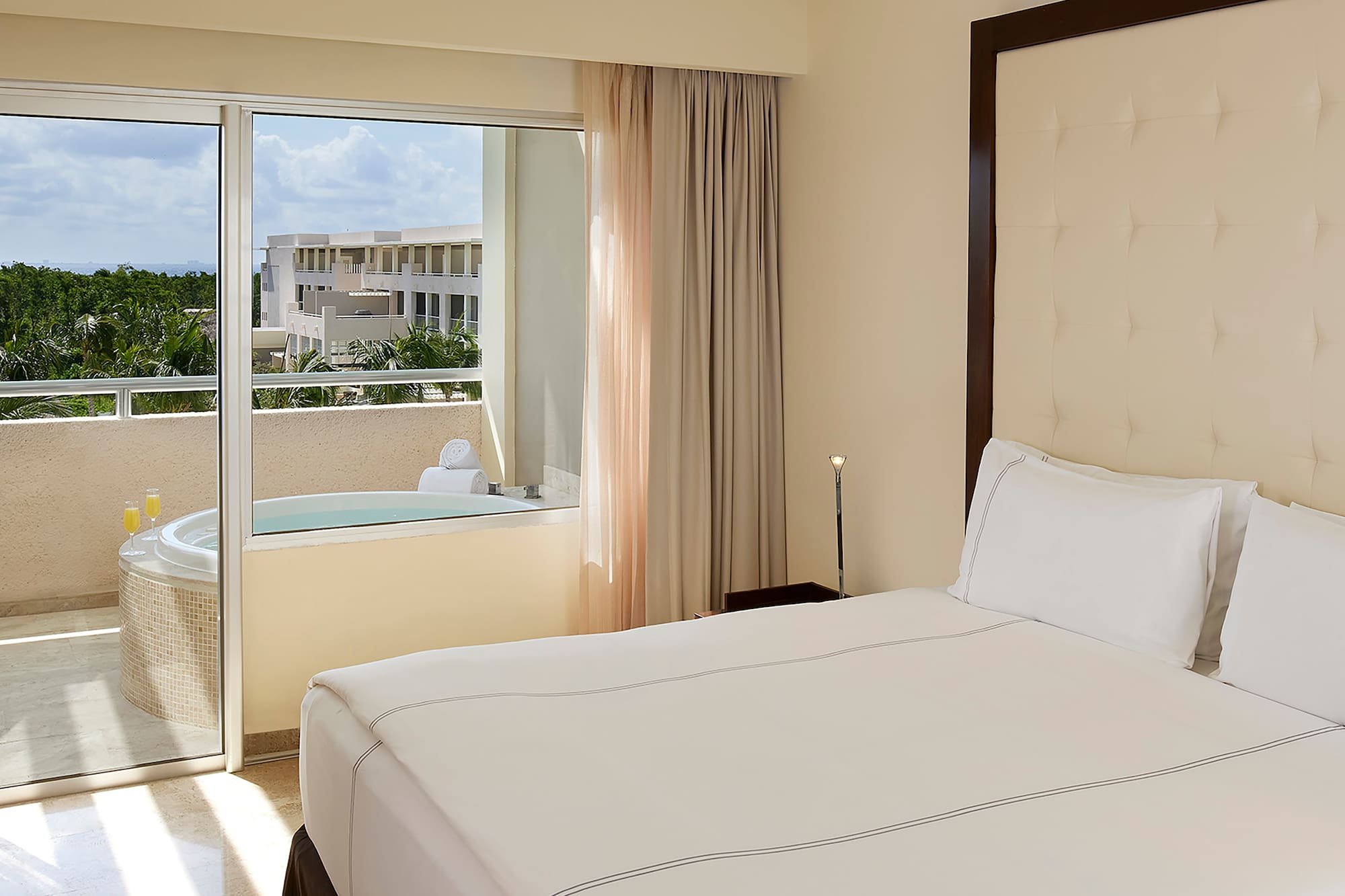 a bed with a glass door and a jacuzzi