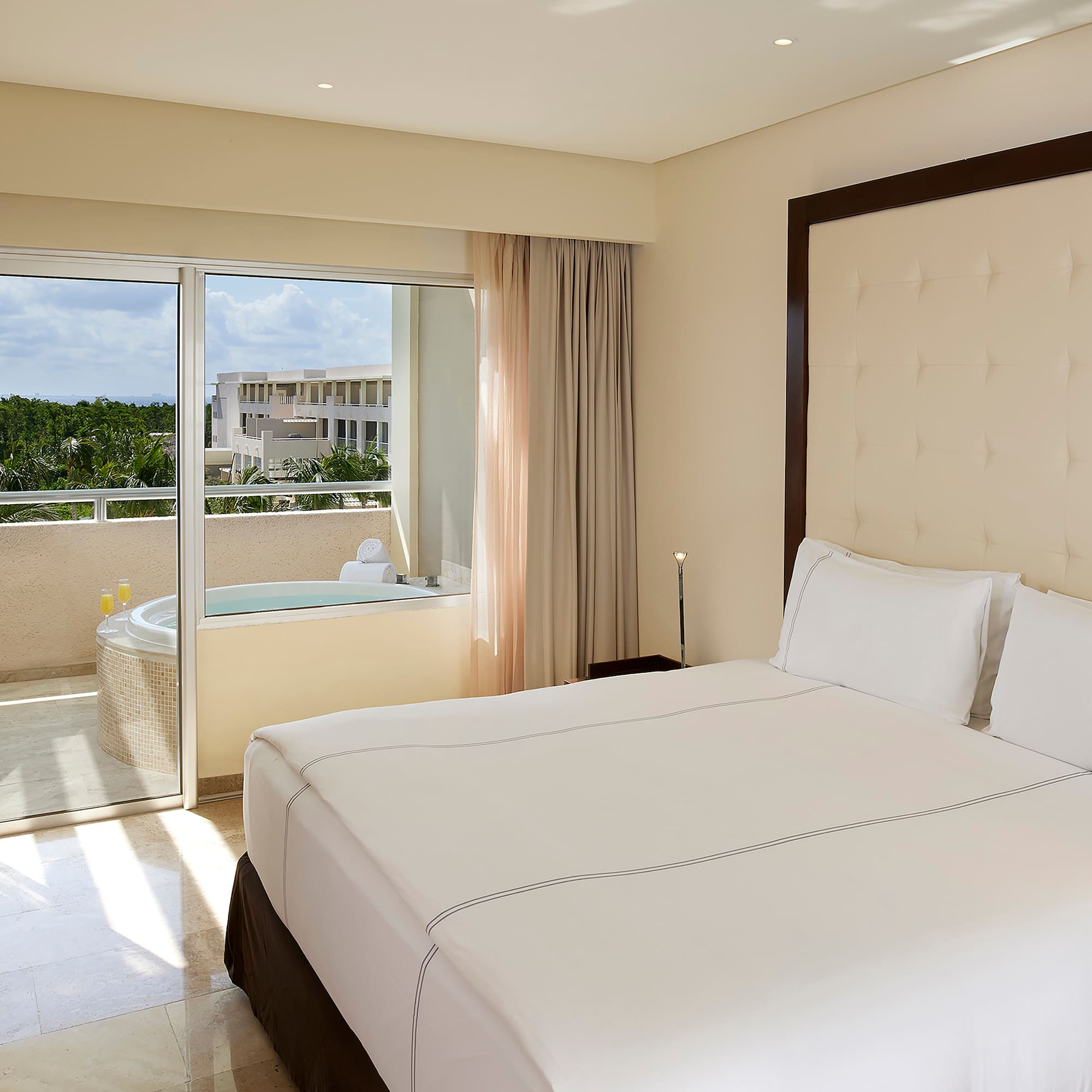 a bed with a glass door and a jacuzzi