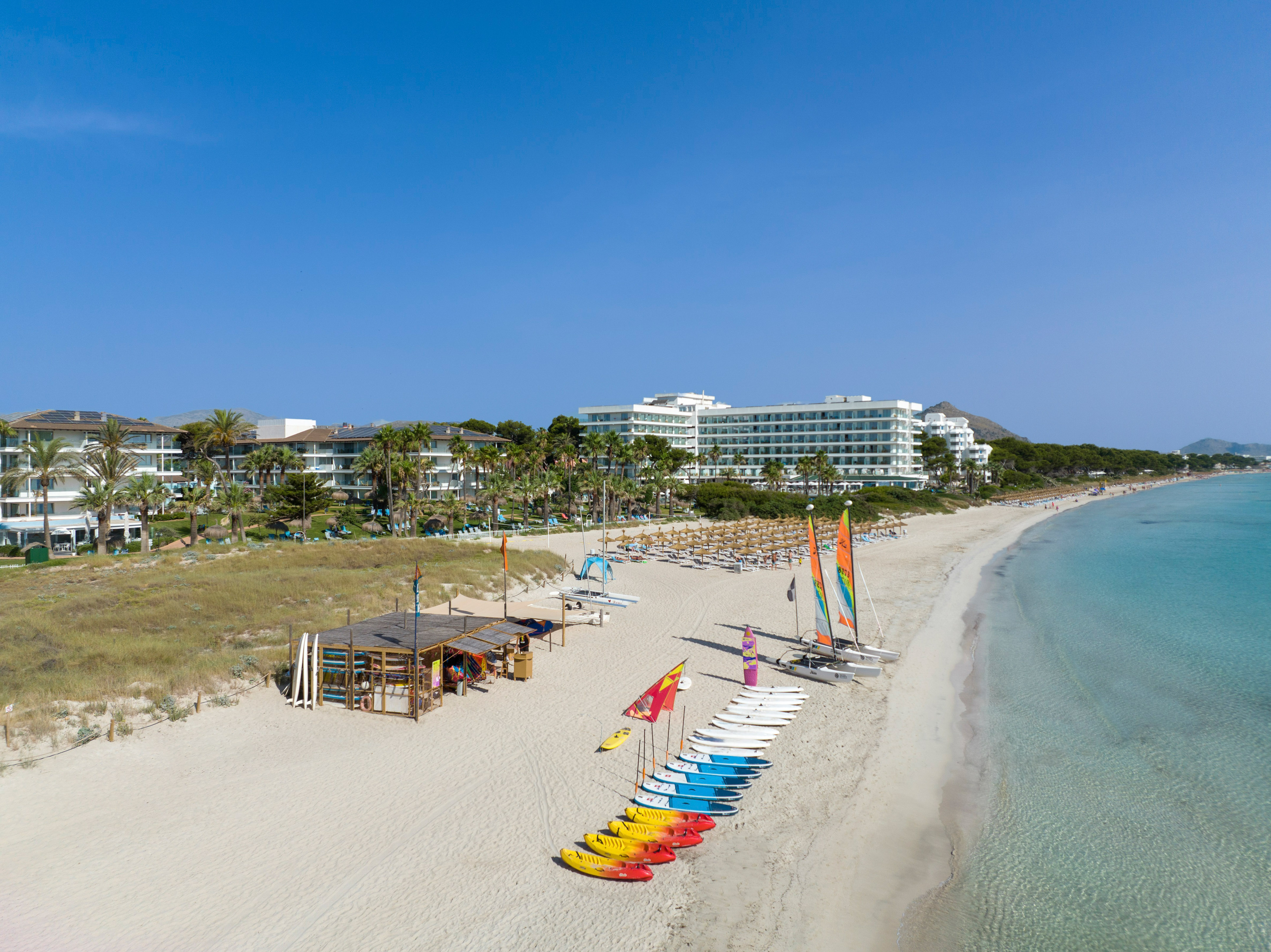 a beach with many chairs and umbrellas
