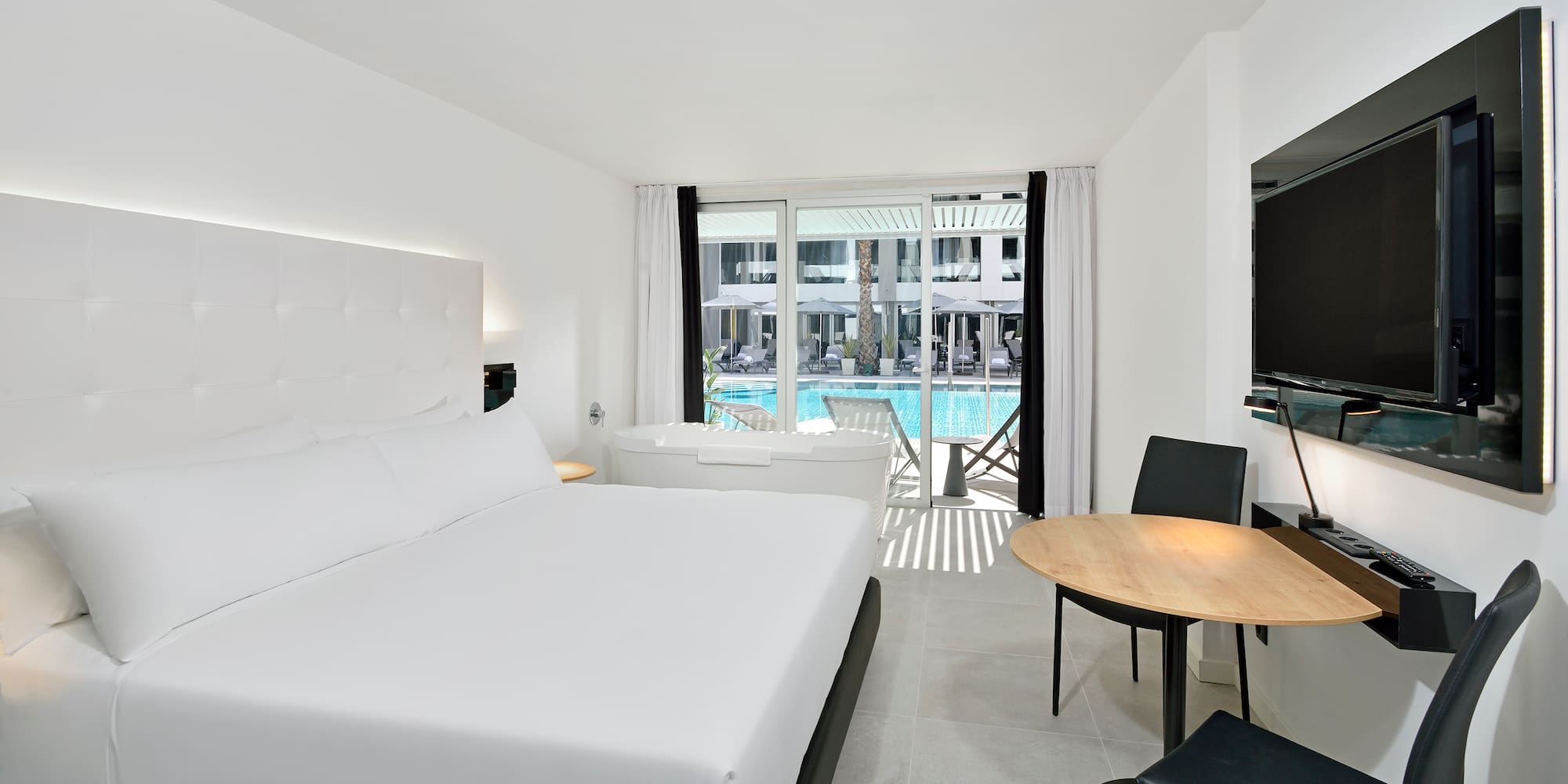 a room with a bed and a tub