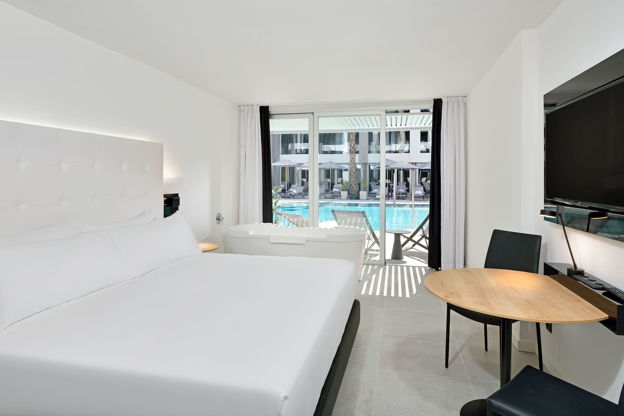 a room with a bed and a tub