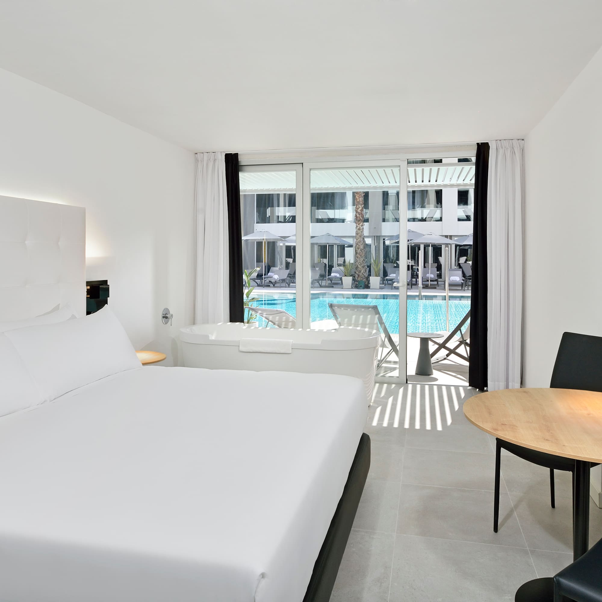 a room with a bed and a tub