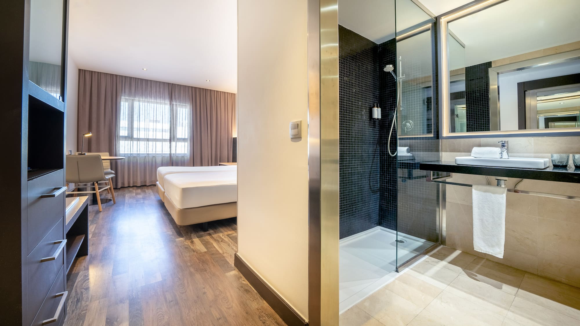 a bathroom with a shower and a bed