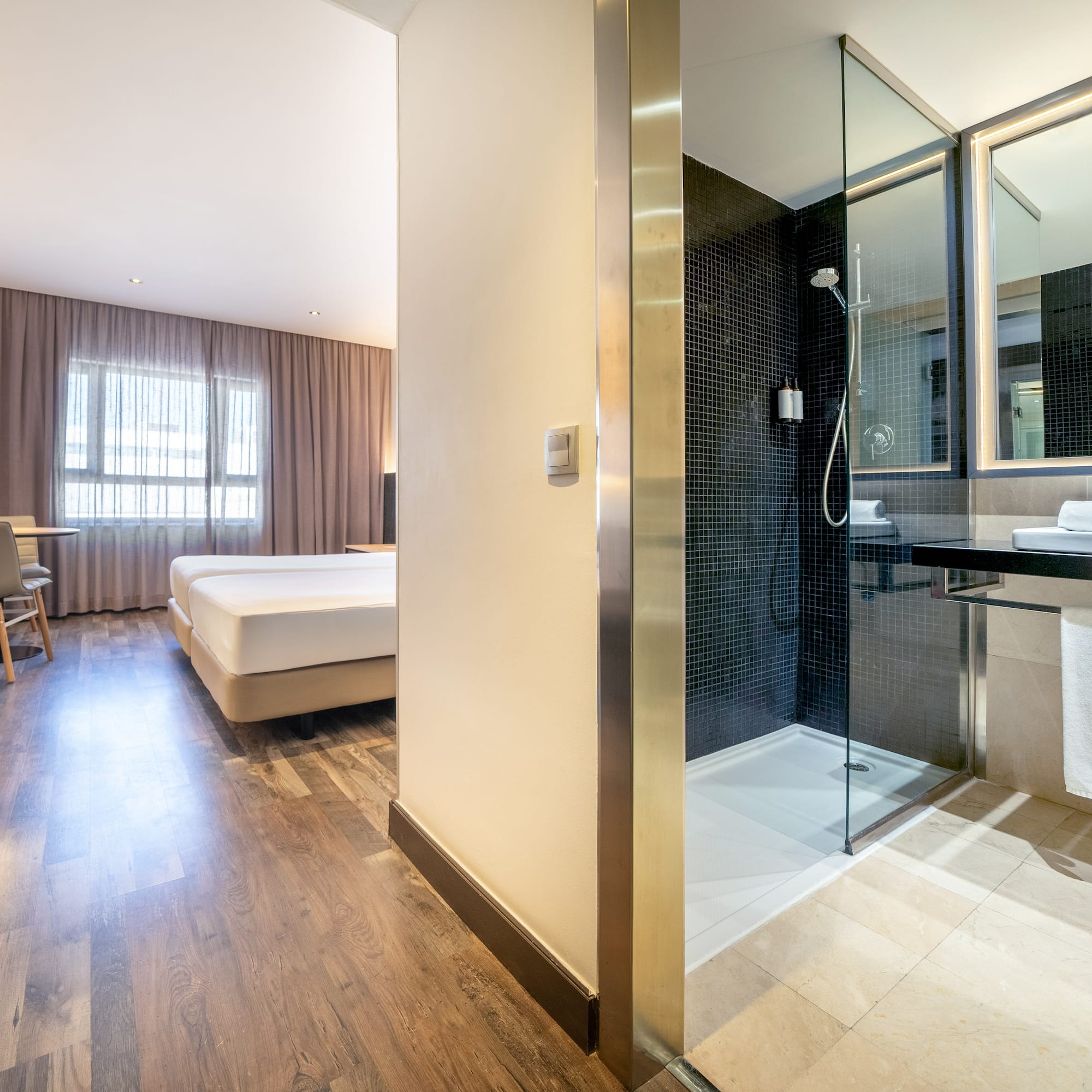 a bathroom with a shower and a bed