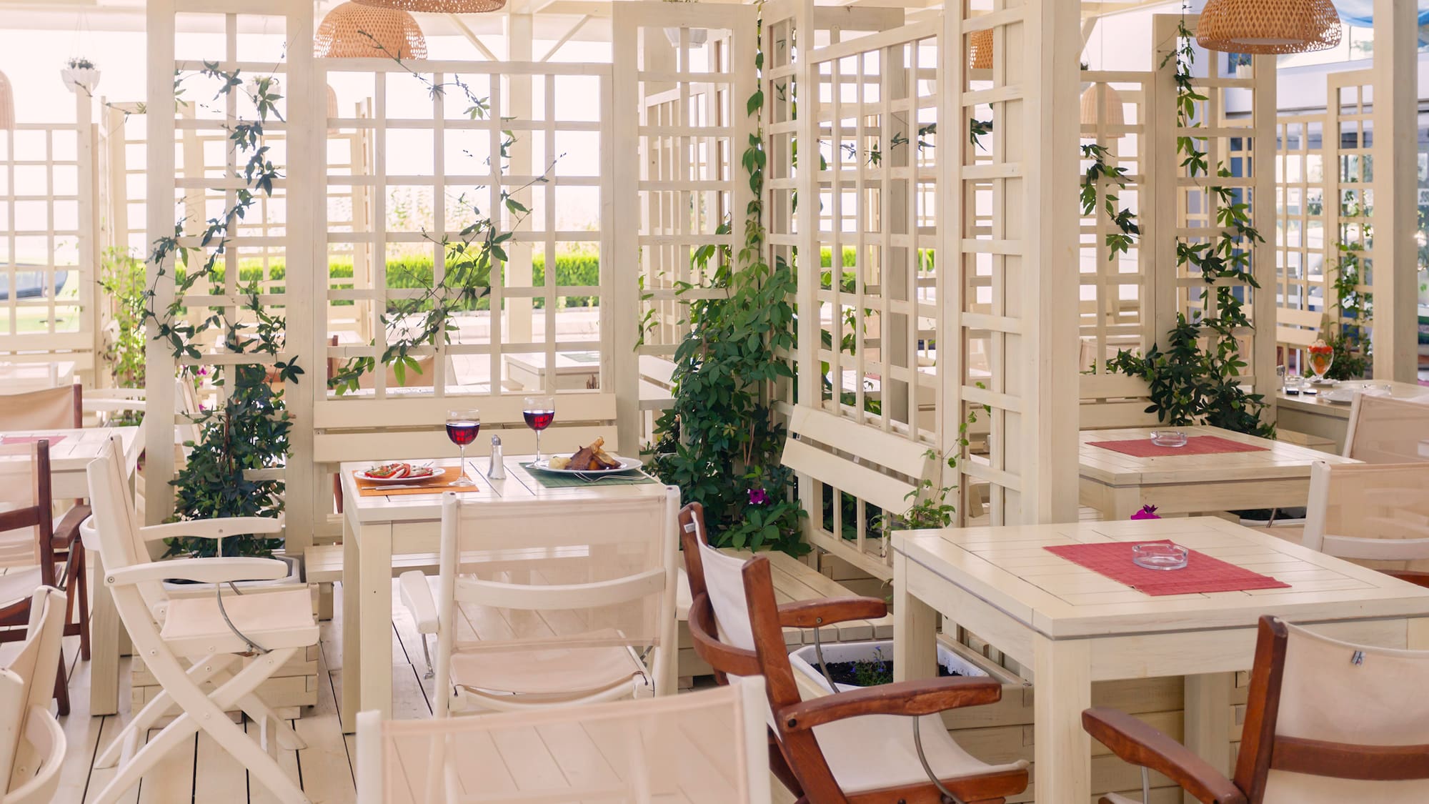 a white room with tables and chairs