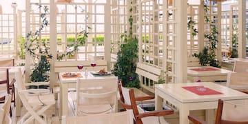 a white room with tables and chairs