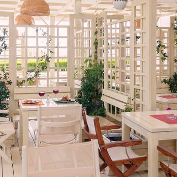 a white room with tables and chairs
