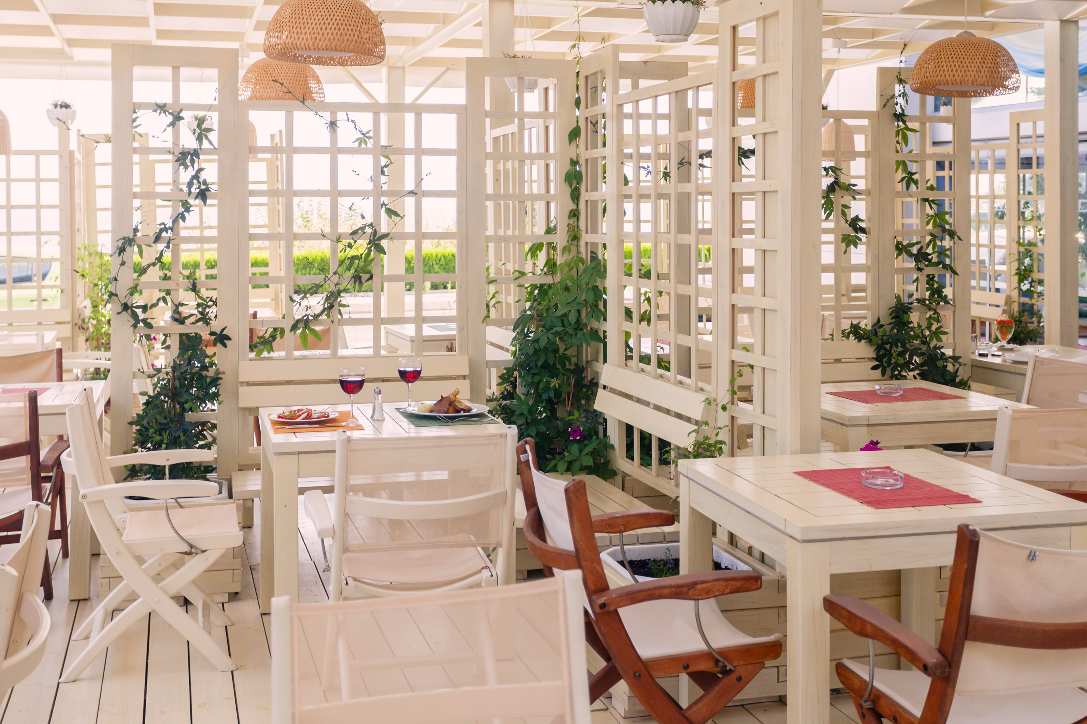 a white room with tables and chairs