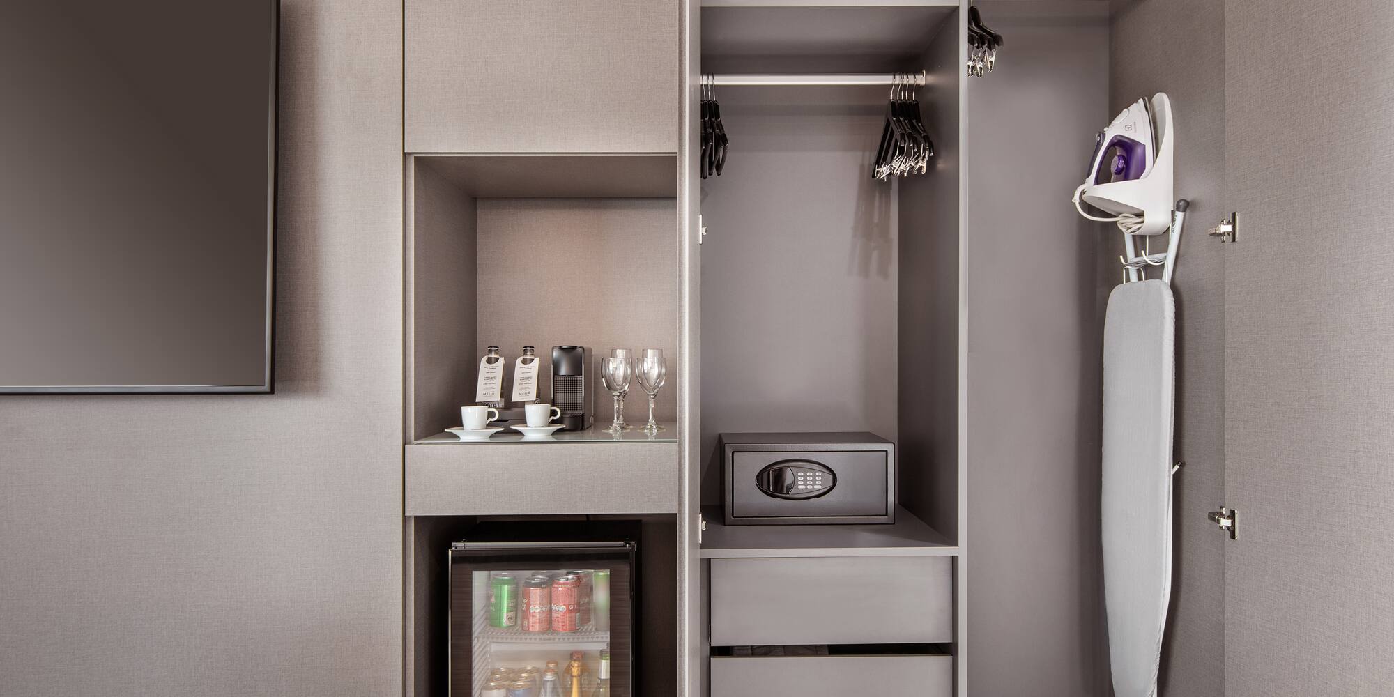 a closet with a small refrigerator and a small microwave