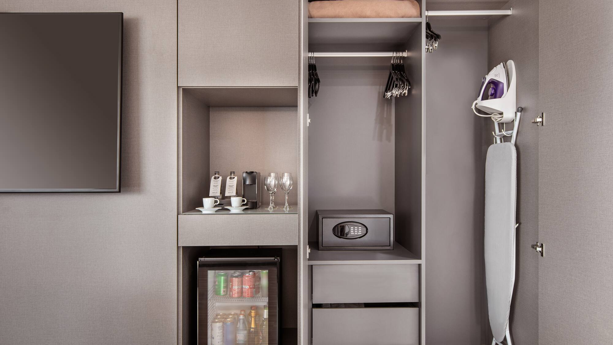 a closet with a small refrigerator and a small microwave