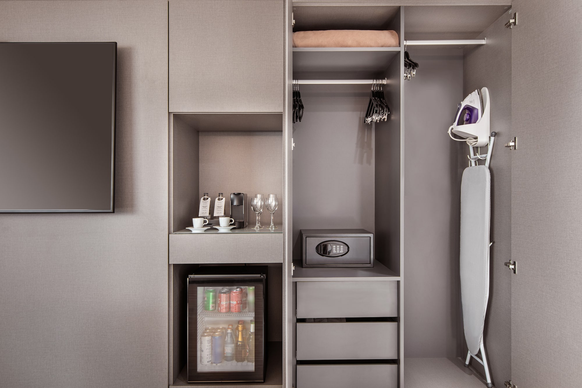 a closet with a small refrigerator and a small microwave