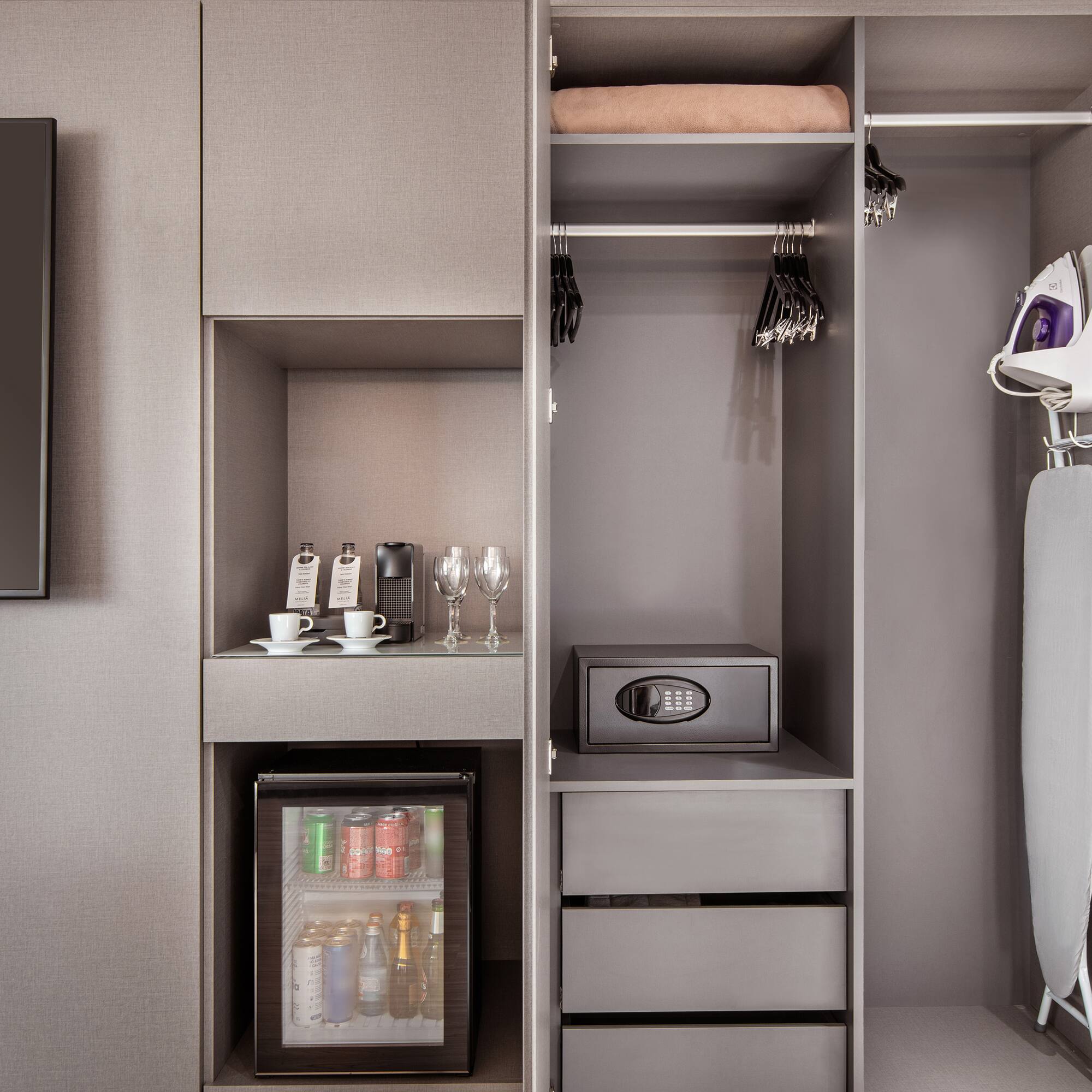 a closet with a small refrigerator and a small microwave