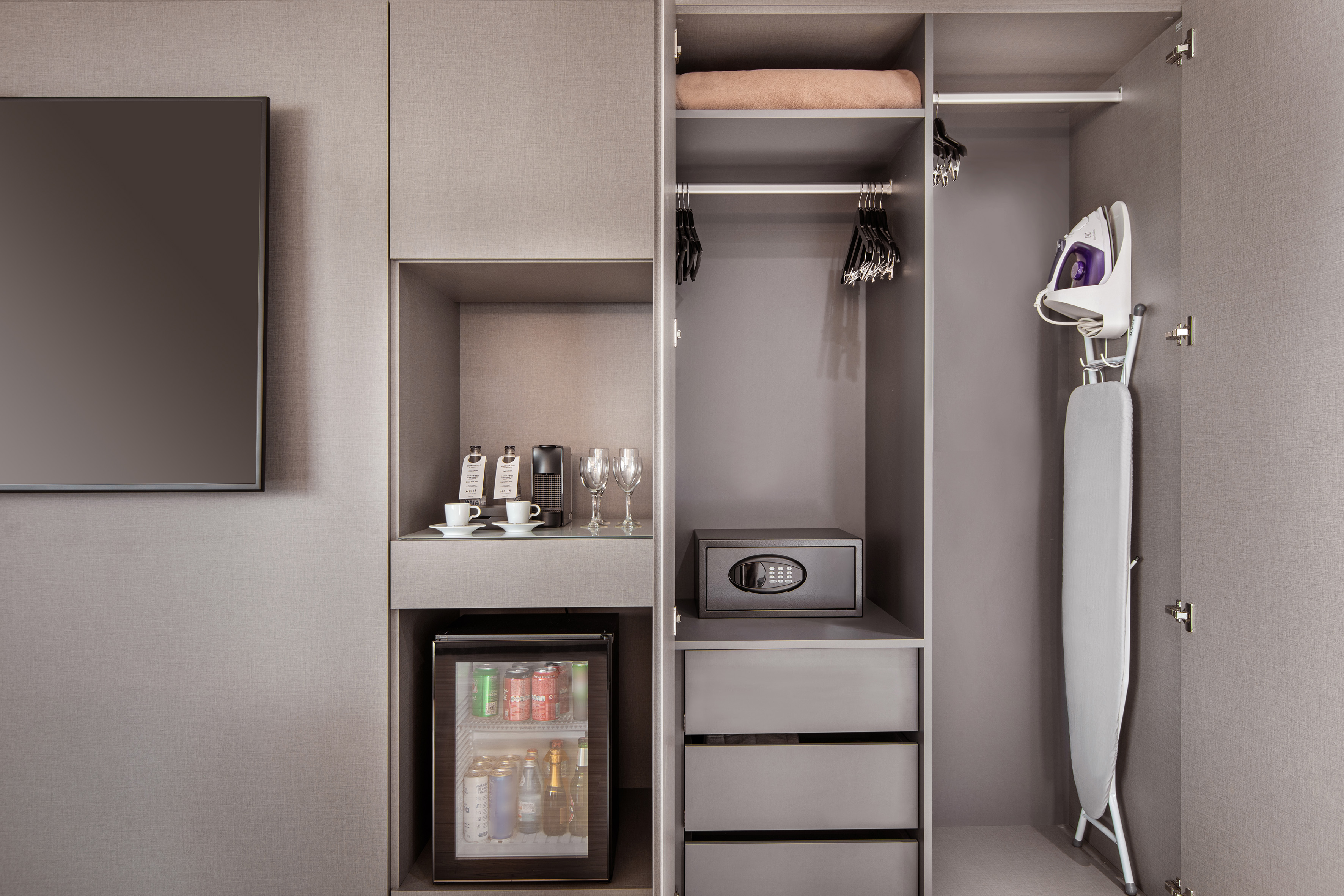 Hotel room amenities: wardrobe, minibar, safe, coffee maker, iron, ironing board.