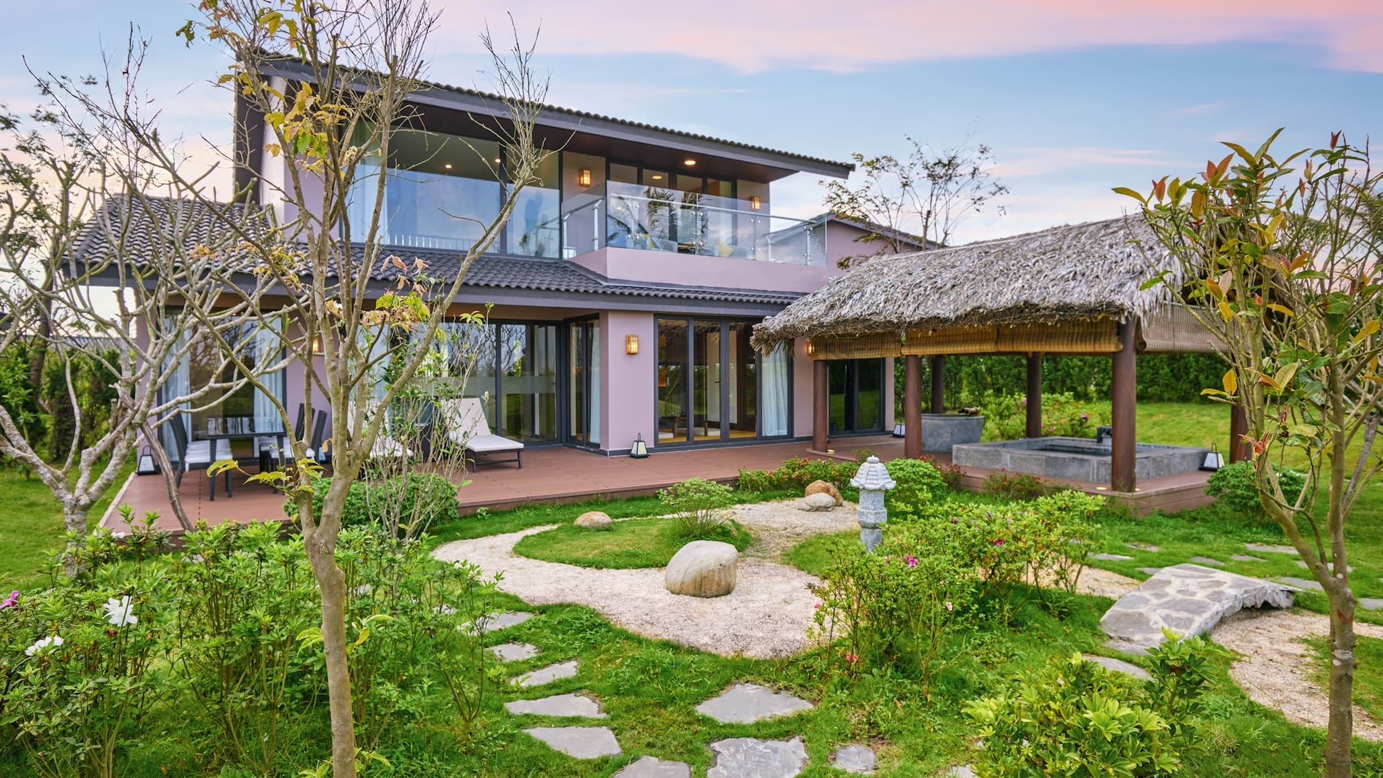 a house with a garden and grass covered patio