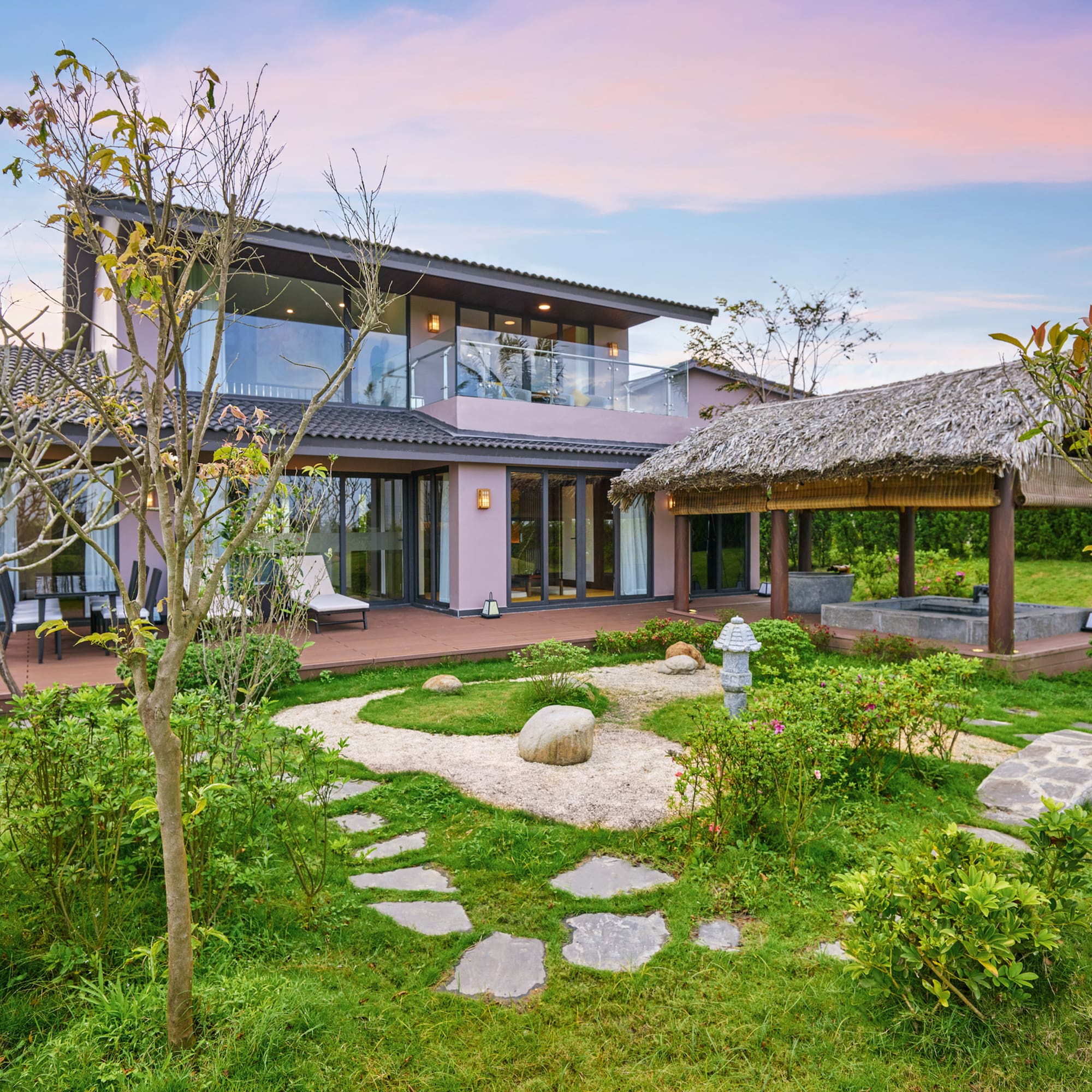 a house with a garden and grass covered patio