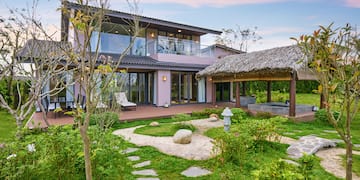 a house with a garden and grass covered patio