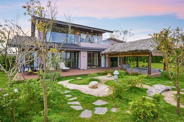 a house with a garden and grass covered patio