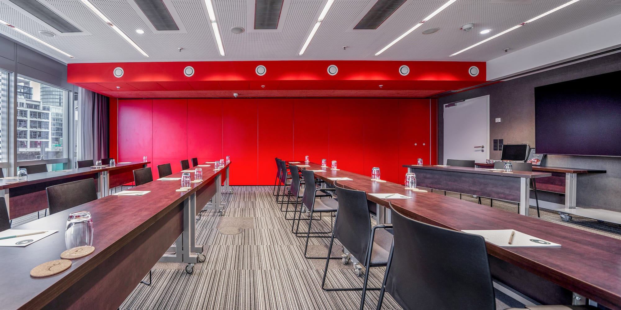 a room with long tables and chairs