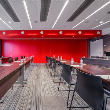 a room with long tables and chairs
