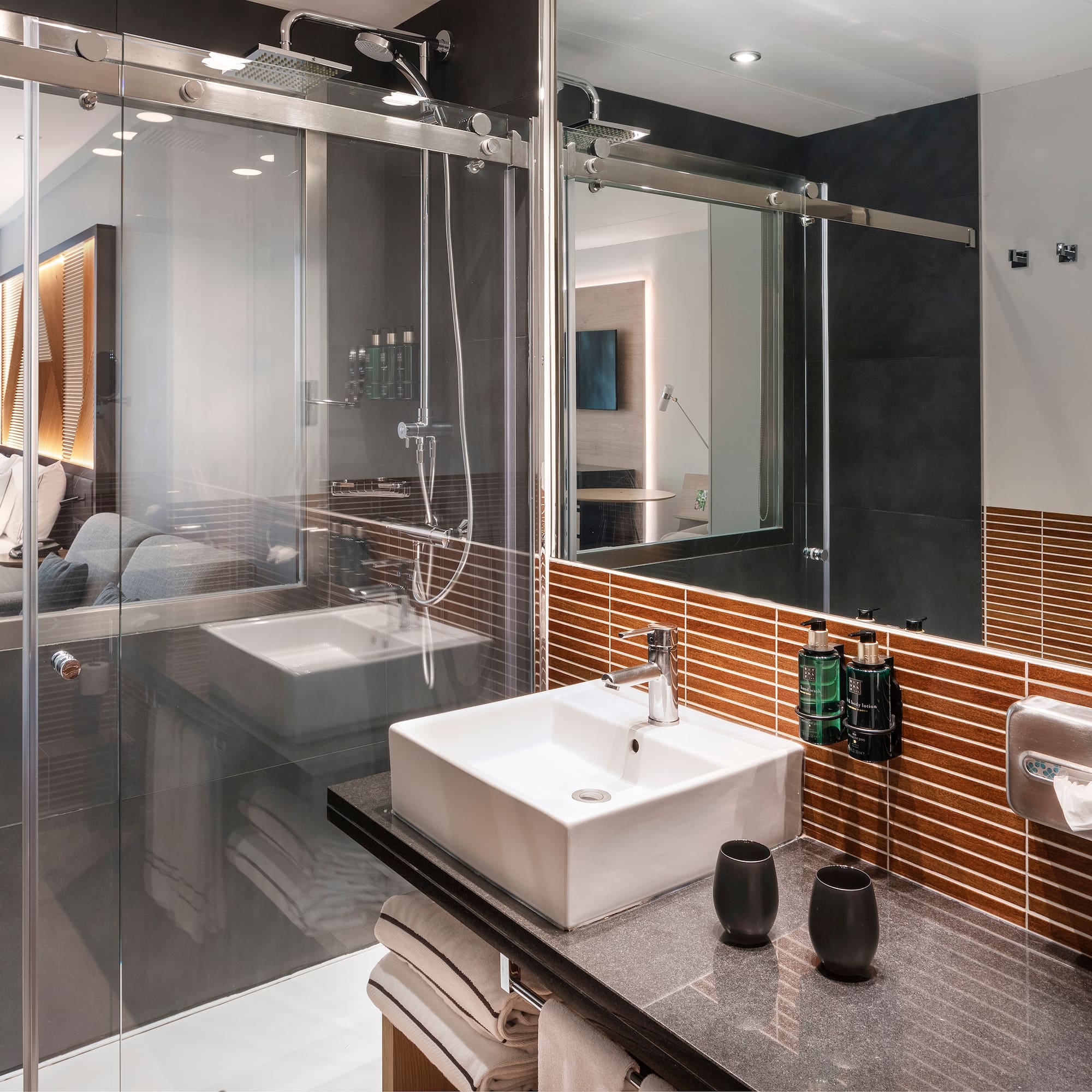 a bathroom with glass doors and sink