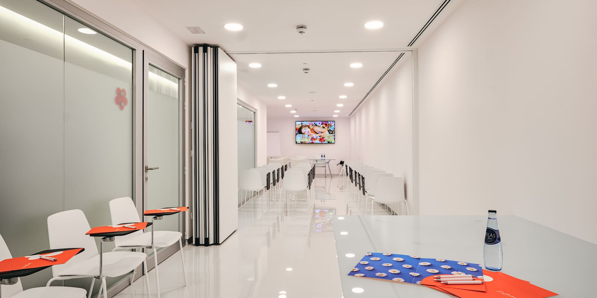 a white room with chairs and tables