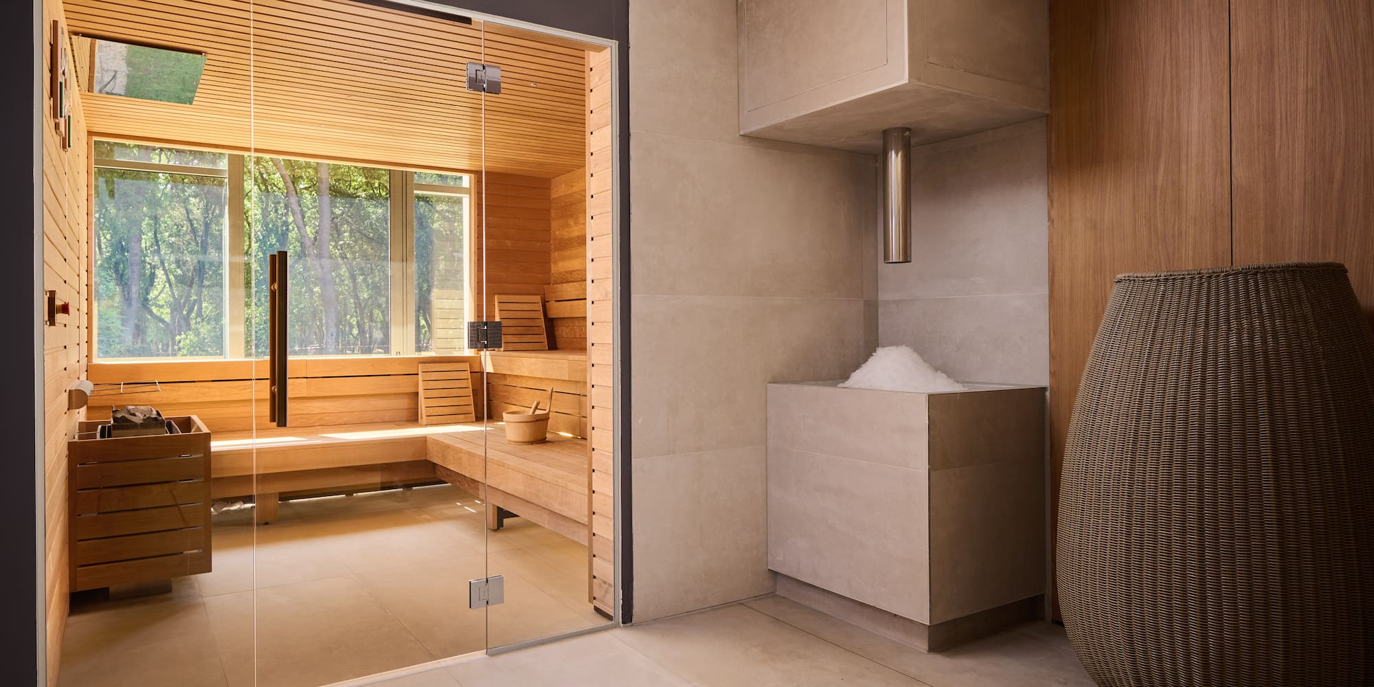 a room with a glass door and a sauna