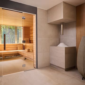 a room with a glass door and a sauna