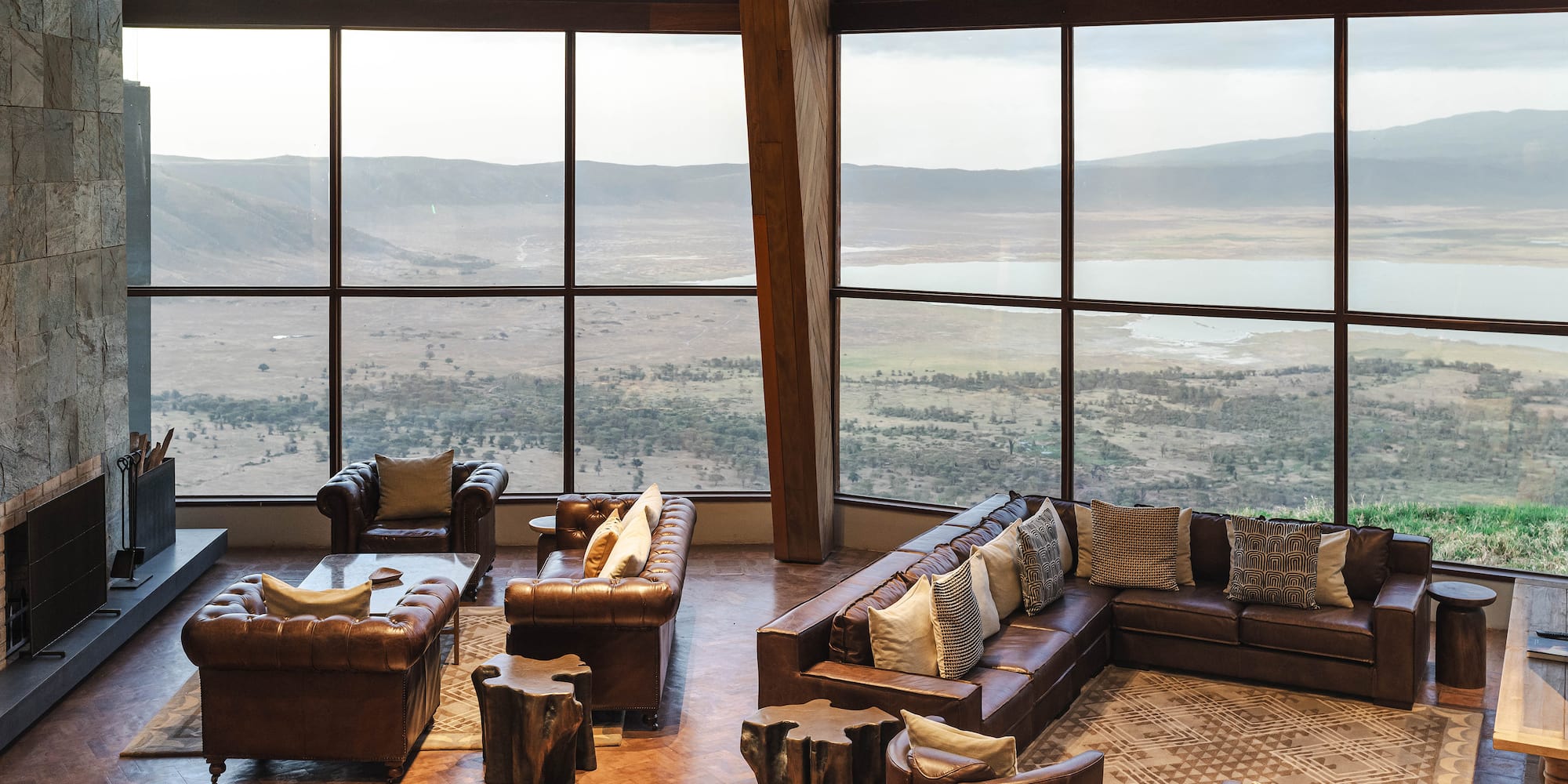 a room with large windows and couches