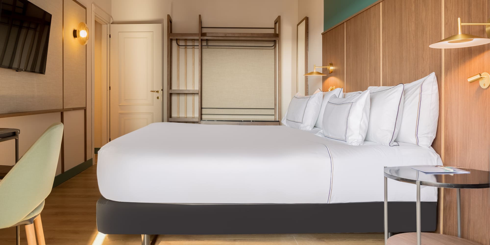 a bed with white sheets and a lamp