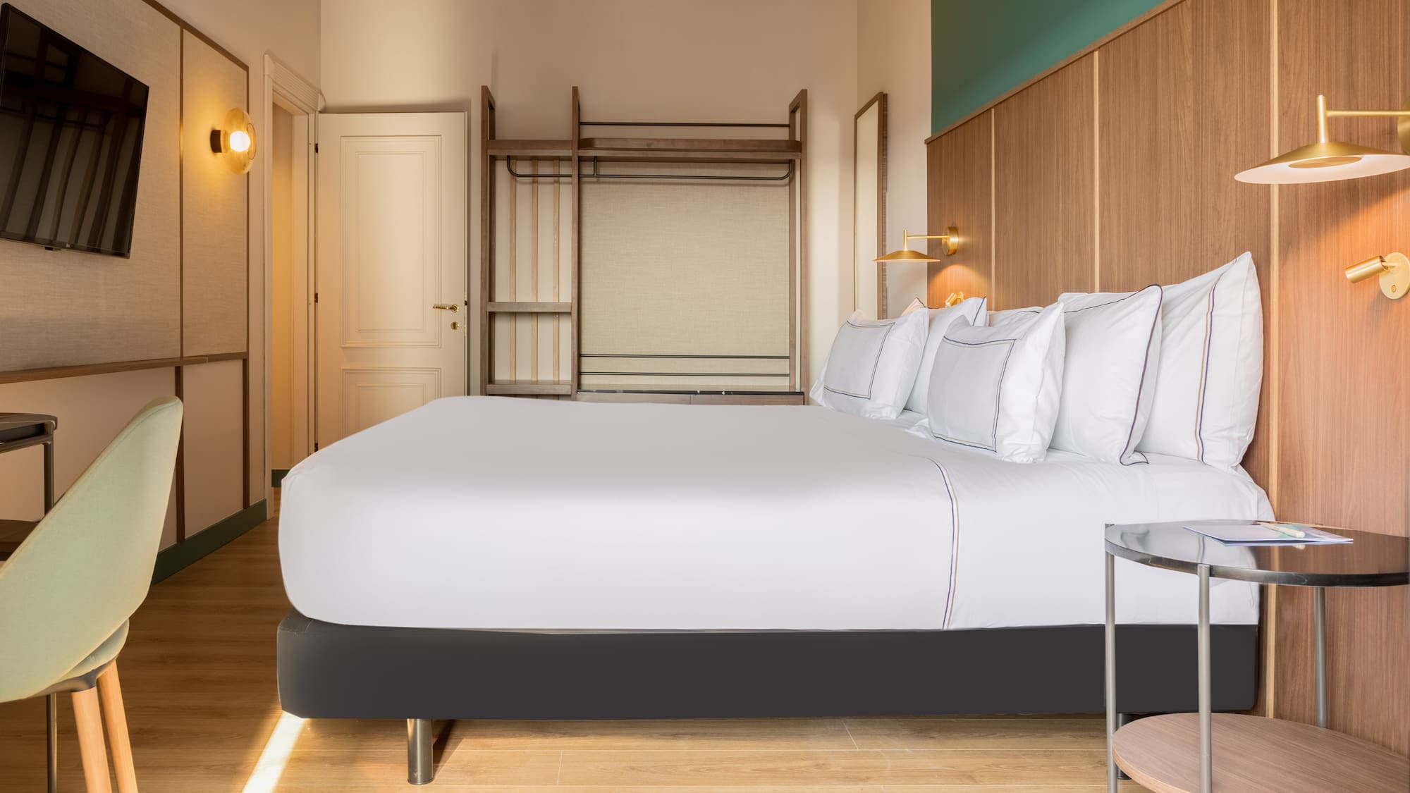 a bed with white sheets and a lamp