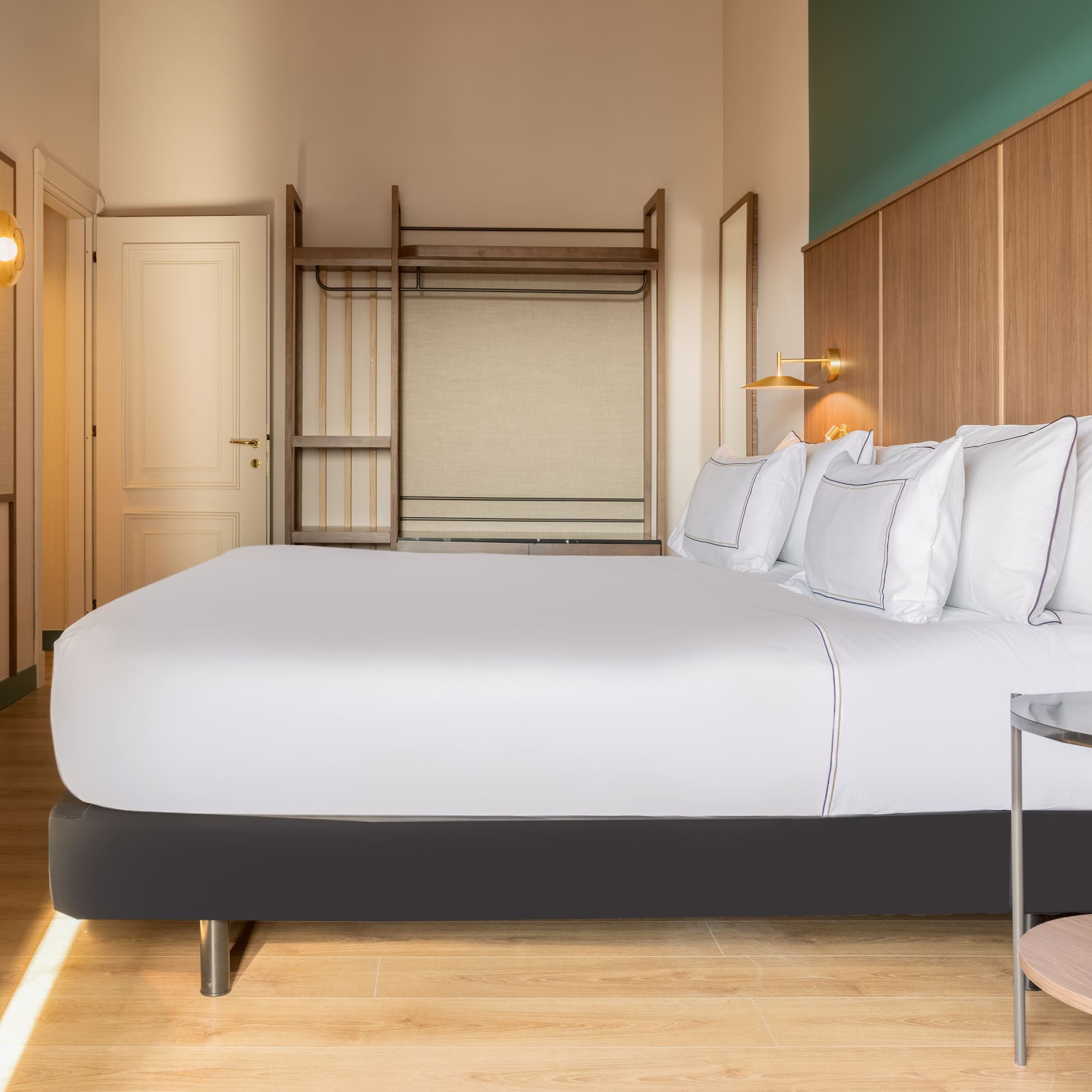 a bed with white sheets and a lamp