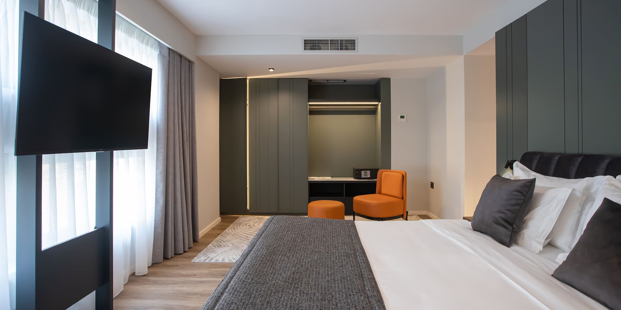 a room with a bed and a television