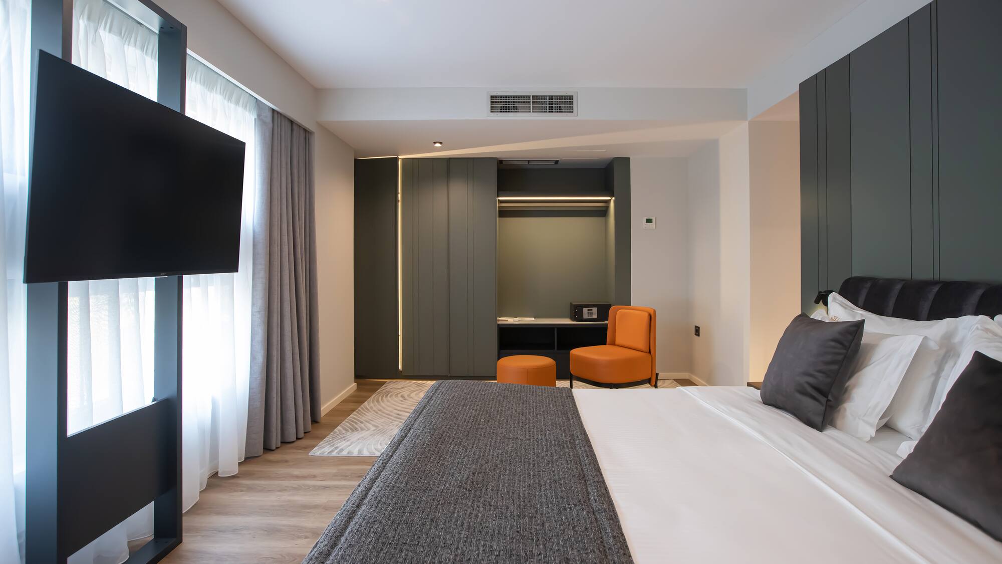 a room with a bed and a television