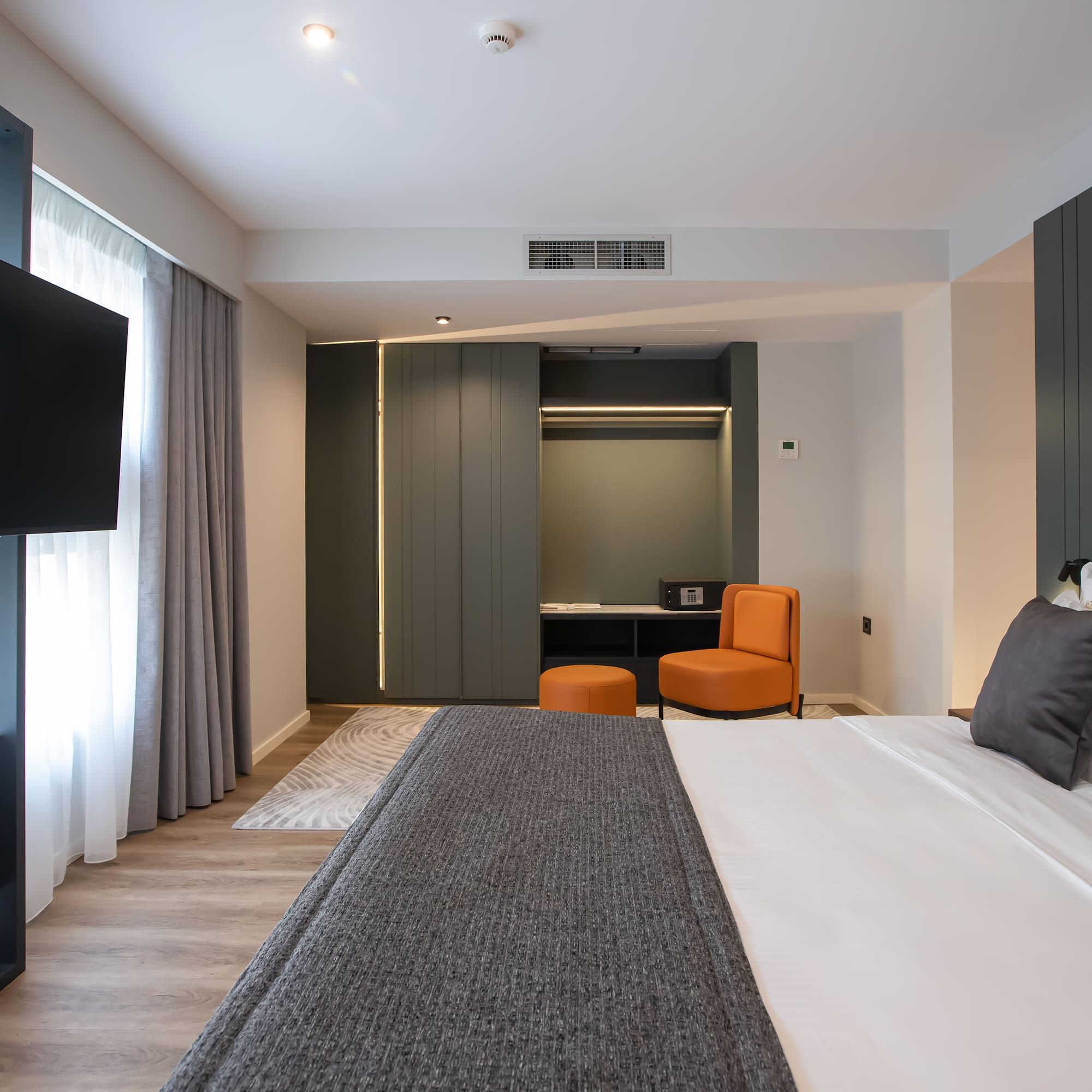 a room with a bed and a television