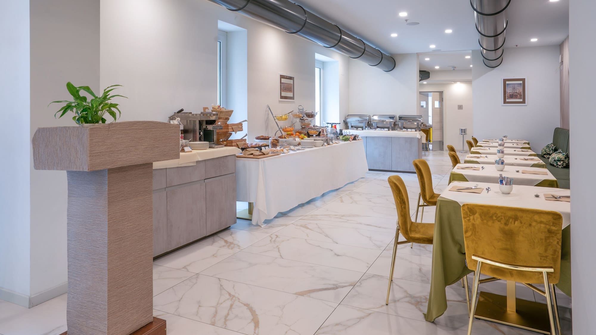 Modern hotel restaurant breakfast buffet with elegant dining area.