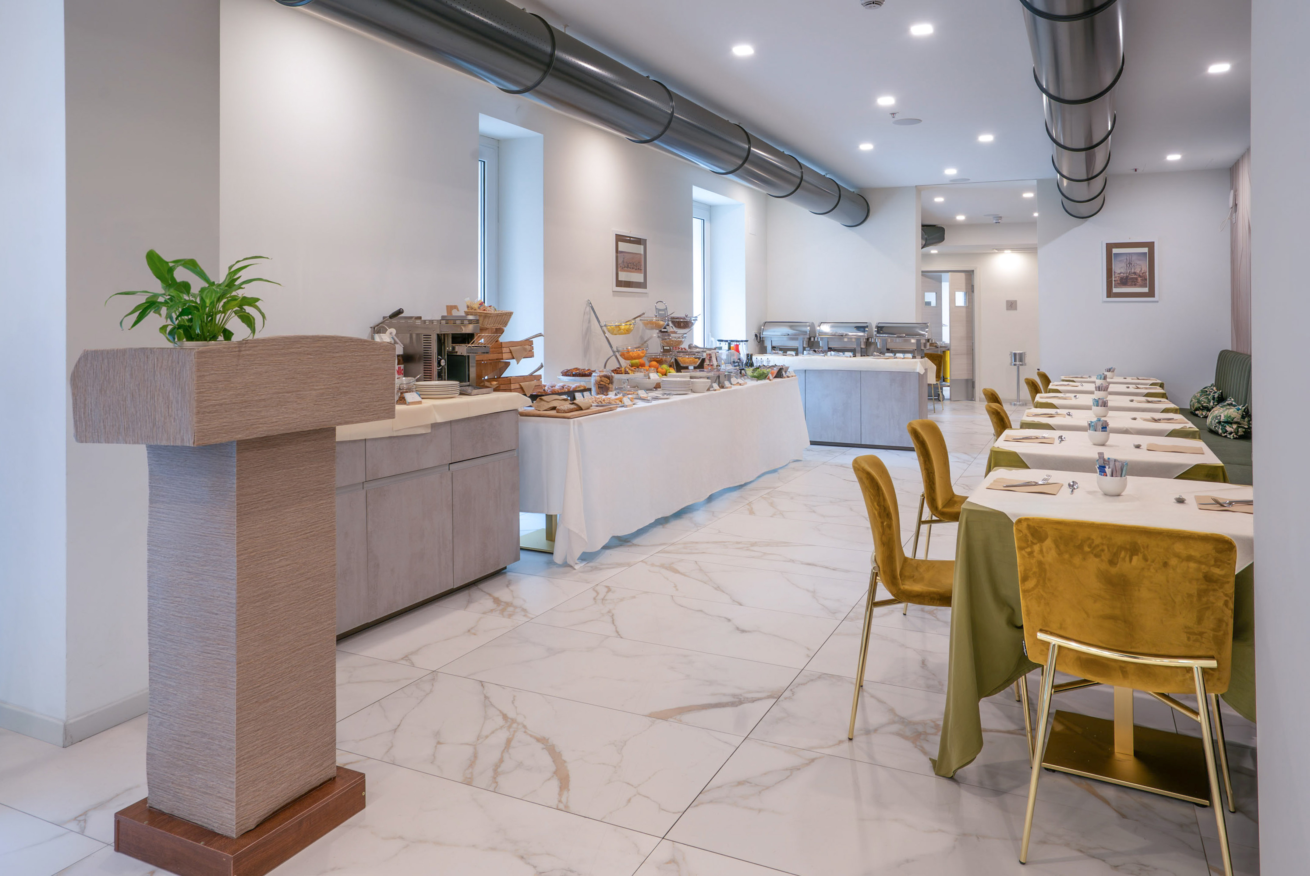 Modern hotel restaurant breakfast buffet with elegant dining area.
