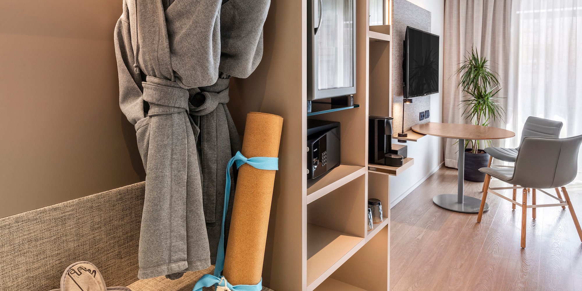 a room with a bathrobe and a tv