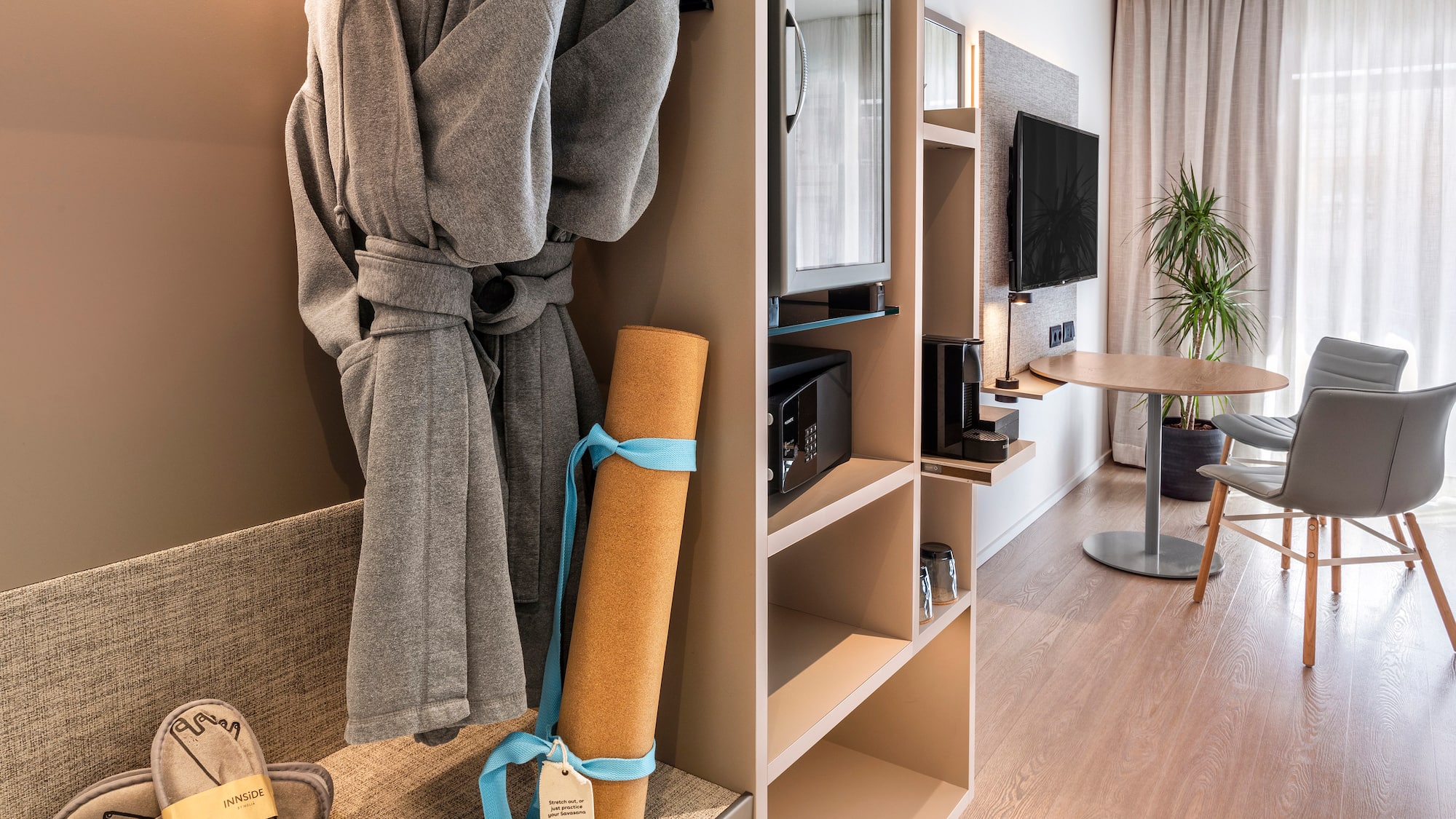 a room with a bathrobe and a tv