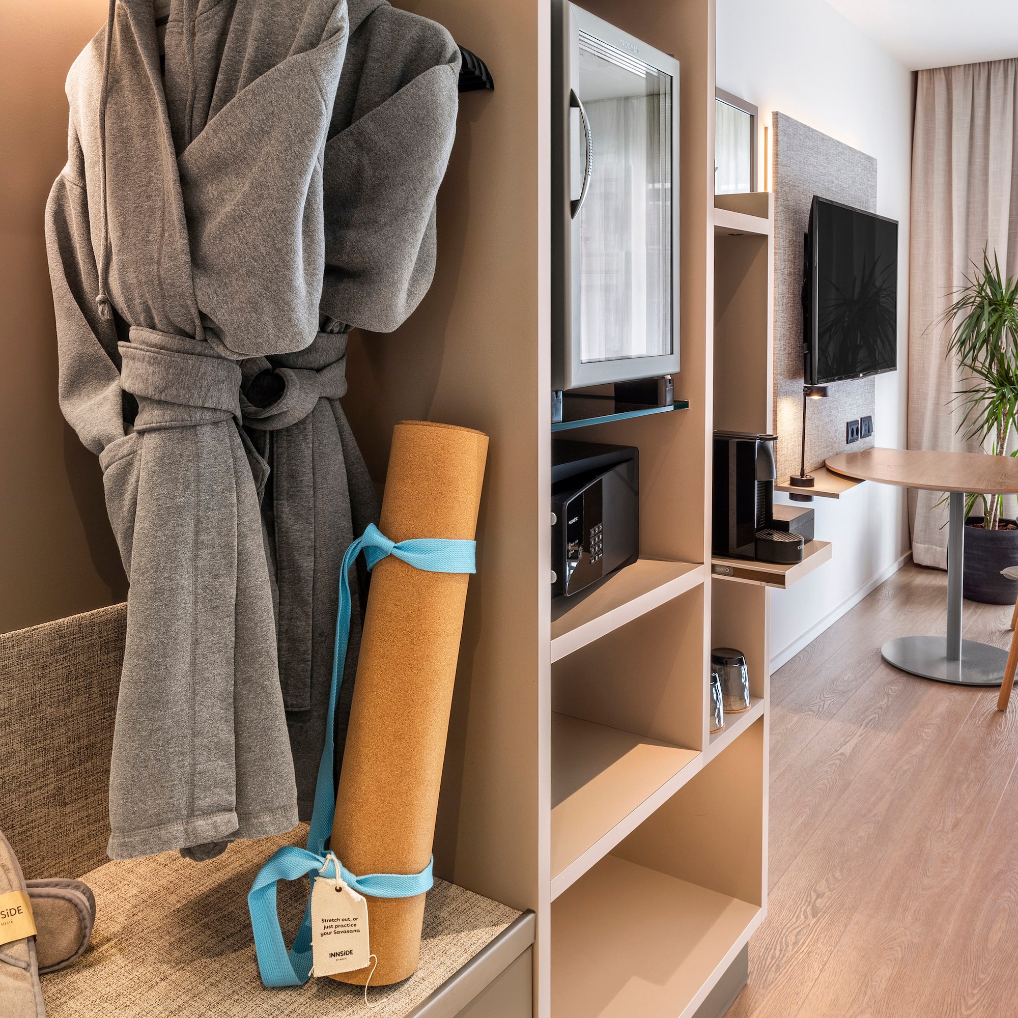 a room with a bathrobe and a tv