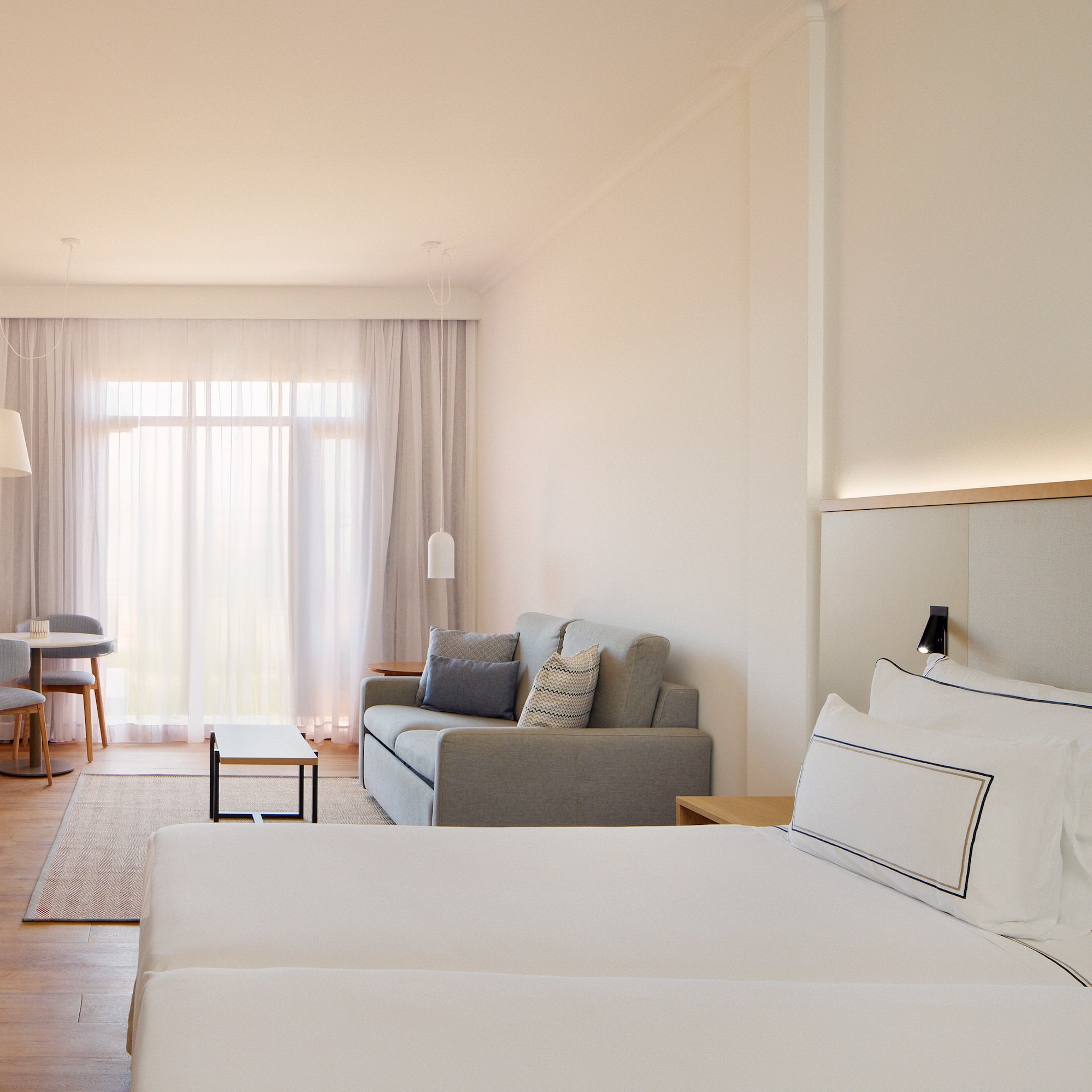 a room with two beds and a couch